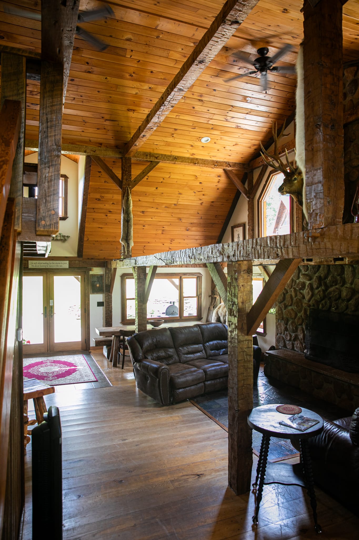 Clara Creek Company, Interior view of The Gasthaus Lodge log cabin rental in Potter County, PA, showcasing rustic design and cozy living space.